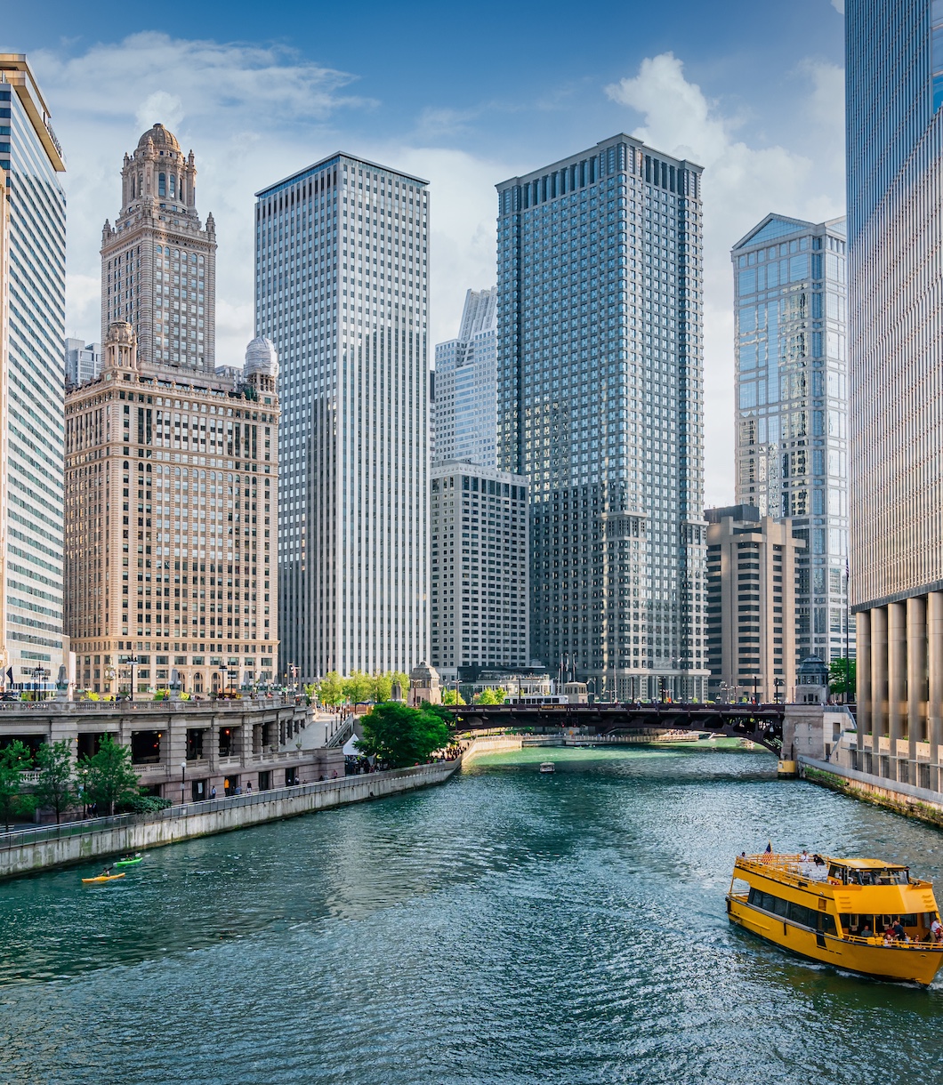The Chicago River flowing between high rise buildings in the Chicago Loop